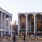 people walking on a sidewalk with Lincoln Center for the Performing Arts in the background