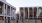 people walking on a sidewalk with Lincoln Center for the Performing Arts in the background