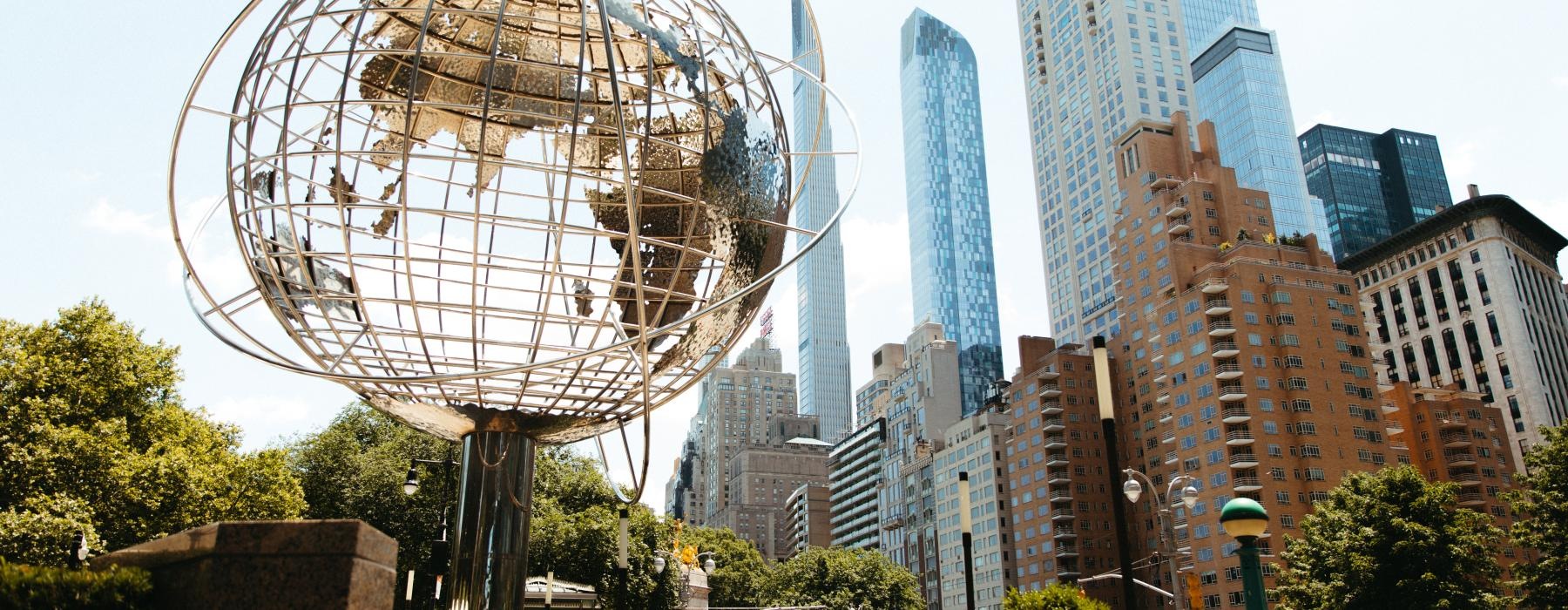 a large metal ball in a city