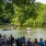 people sitting at tables in front of a river