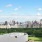 a city skyline with trees and grass